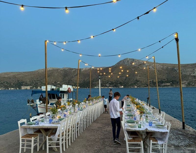 Long table, harbour, string lights